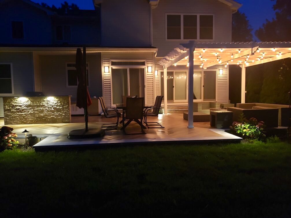 Energizing and Inviting, Accent Lighting Transforms this New York Home with a Herringbone Deck, Huge Pergola, and Gourmet Kitchen