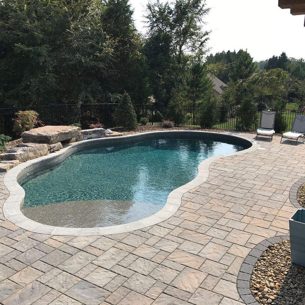 Gorgeous Stone Lover’s Dream Backyard with Custom Pool, Fire Pit, Outdoor Kitchen, and Cedar Pergola