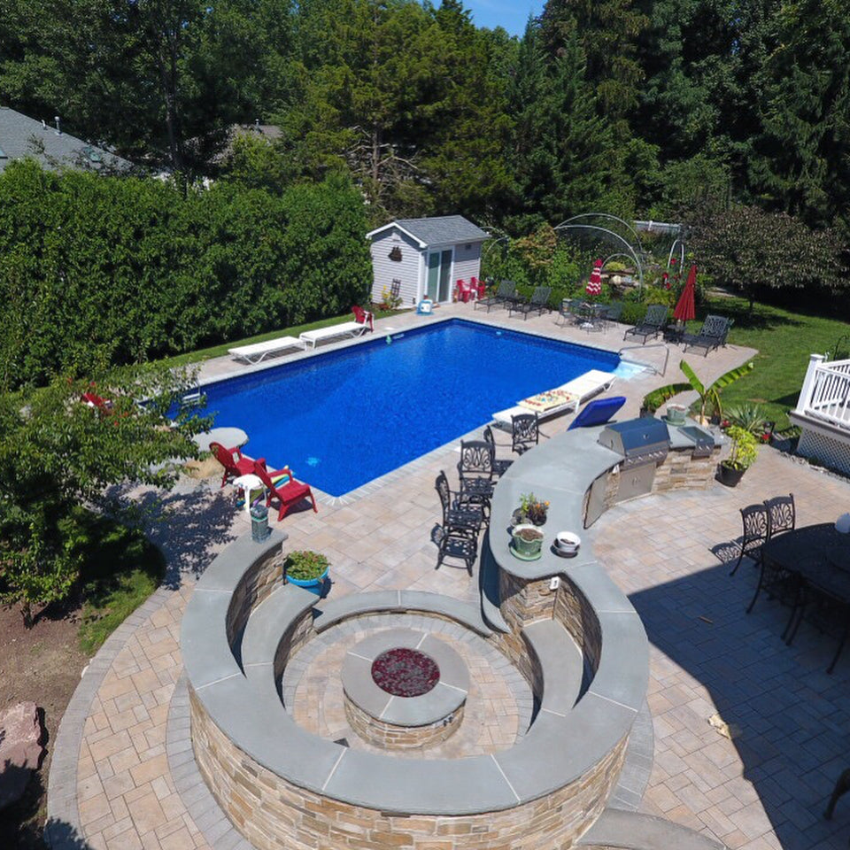 Large Pool, Stone Custom Island, Distinctive Circular Fire Pit, Incredible Backyard Hangout in New Jersey