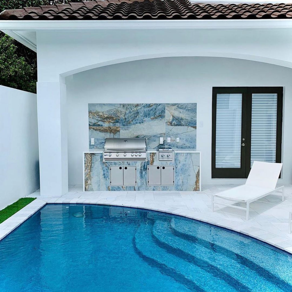 Serene and Modern Hideaway with Vibrant Tiled Grill Island, White Nano Glass Countertops, and Custom Pool