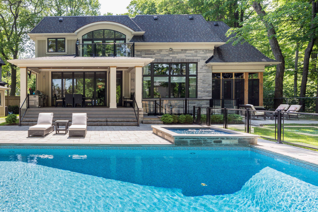 Toronto Oasis: Transitional Elegance with a Glass Wall System, Inviting Pool, and Outdoor Patio Kitchen