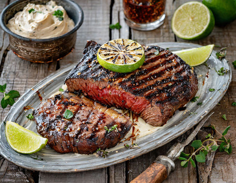 Grilled Chipotle-Rubbed Steaks with Lime Butter
