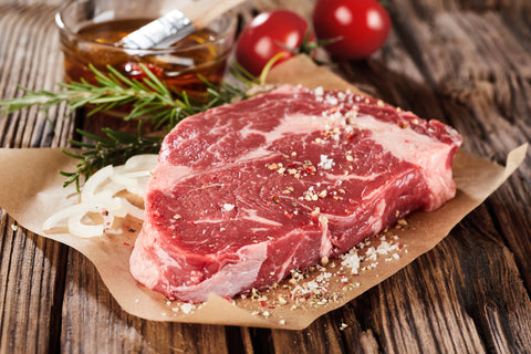 Gorgeous, seasoned raw steak ready to throw on the grill