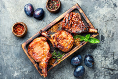 Grilled Pork Chops with Plums, Halloumi, and Lemon